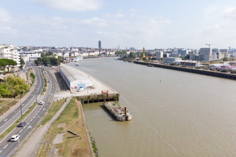 a boat is docked on the side of a river