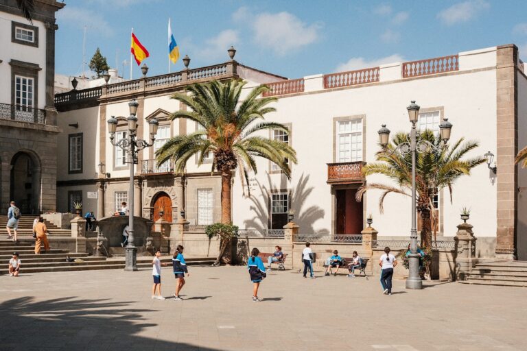 A group of people playing soccer in front of a building