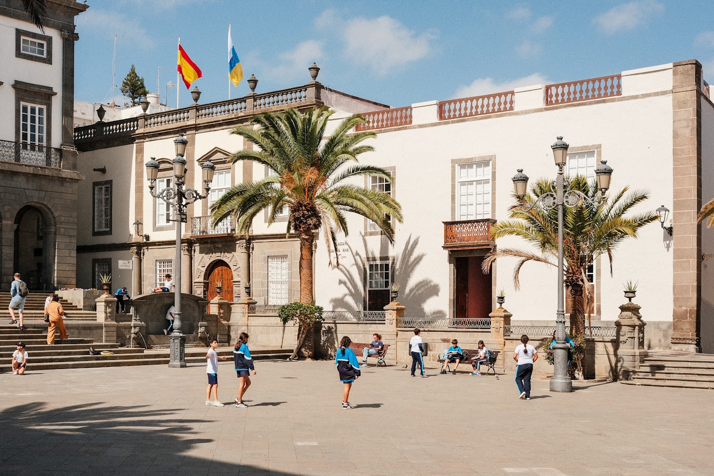 A group of people playing soccer in front of a building
